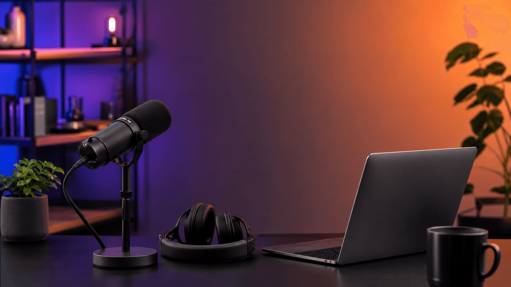 Laptop podcast desk with microphone and headphones